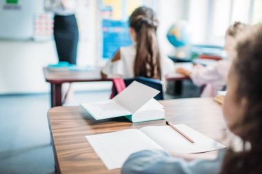 depositphotos_163713532-stock-photo-kids-sitting-at-desks-in